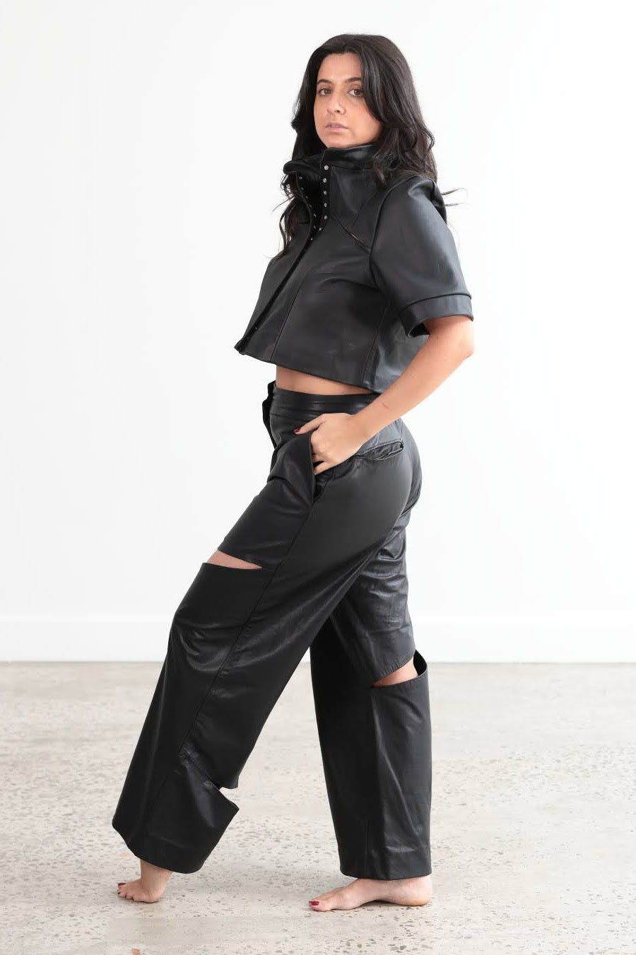 Splice cut out combo of full length wide leg pants and cropped shirt/jacket.