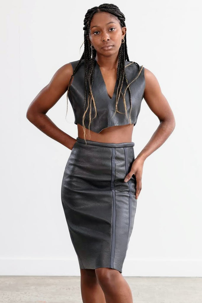 Grey leather and stretch set skirt and vest. Model wears a size 10.