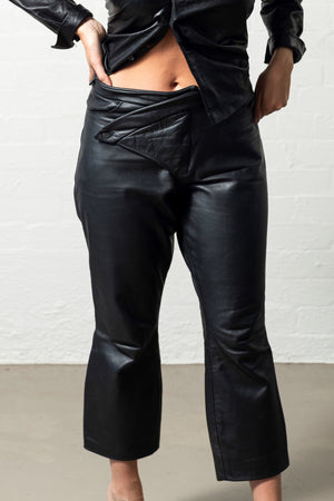 Cropped Asymmetrical drop over waist with buttons, zip and pockets