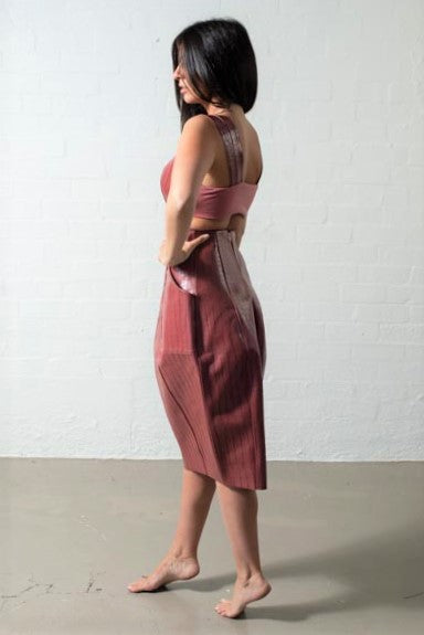 side angle of ribbed leather bra and matching pink tulip skirt with large pockets, fitted waist and angles panels to elongate 